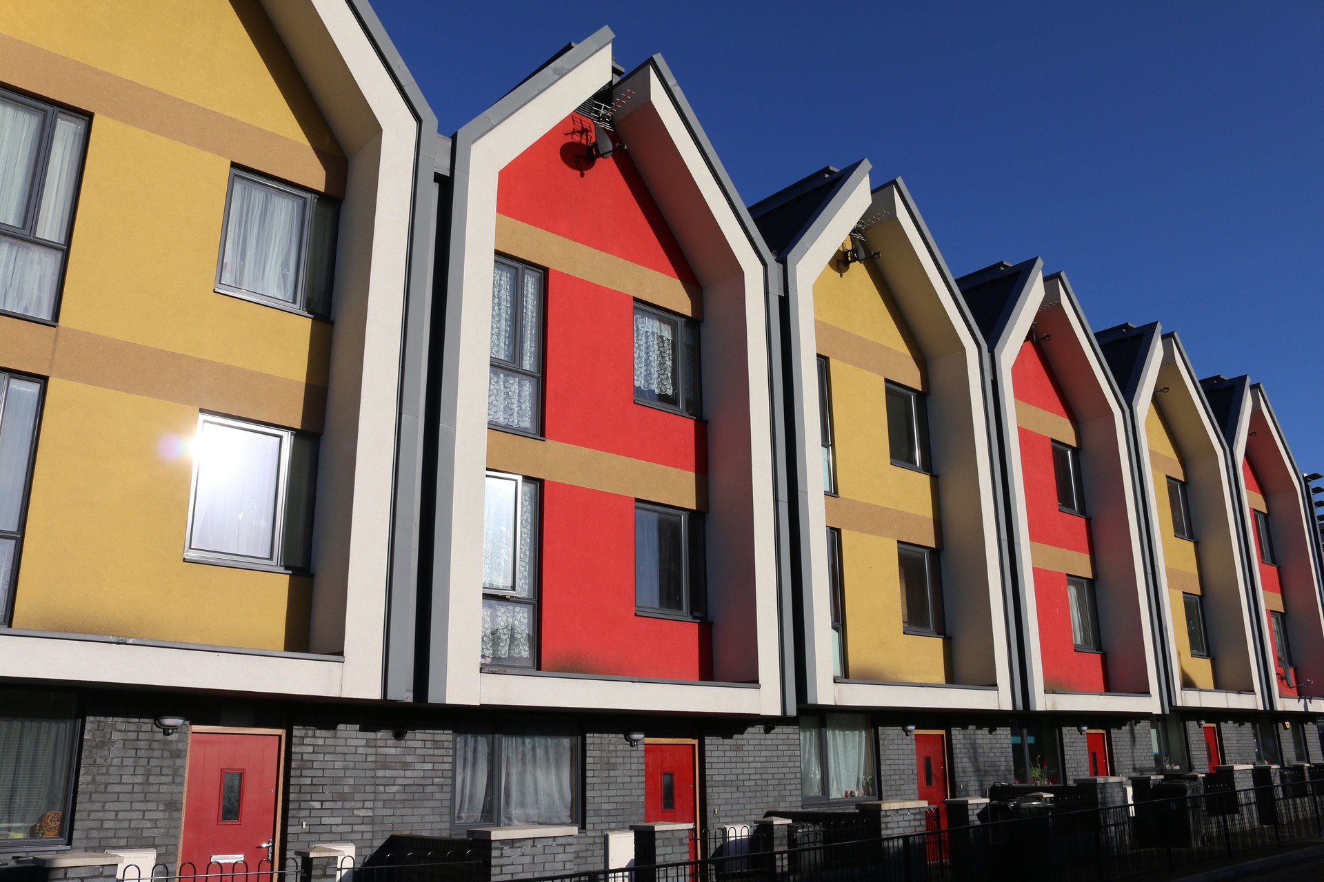 Image of urban residential district, vibrantly coloured modern terrace houses